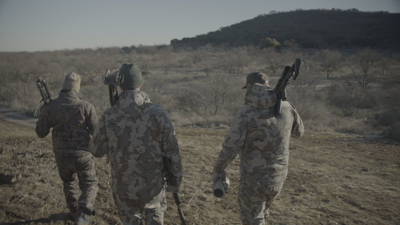 Hunting partners walking together across open country